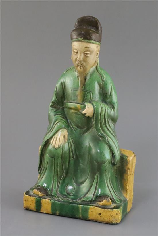 A Chinese sancai ridge tile modelled as the seated figure of Guandi, Ming dynasty, H. 30cm